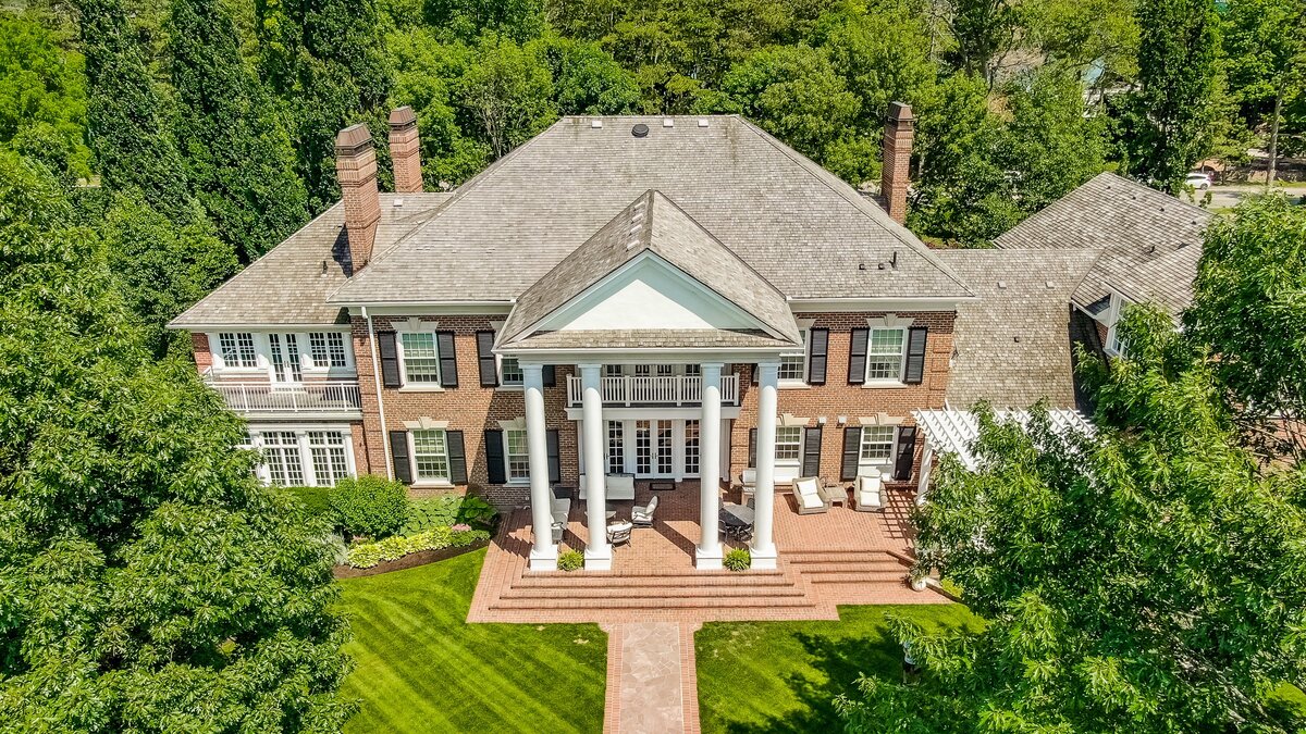 Aerial view of brick Colonial estate